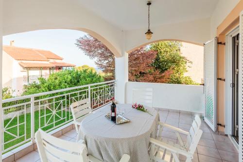a patio with a table and chairs on a balcony at Casa Nebari Seaside Retreats - Fully Equipped, Ideal Spot in Petalidhion