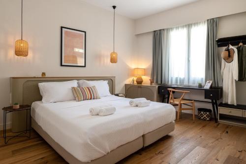 a bedroom with a bed with two towels on it at Casa Natura in Rhodes Town