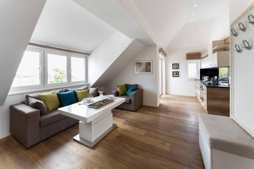 a living room with a couch and a table at Triangle Apartments in Gießhübl