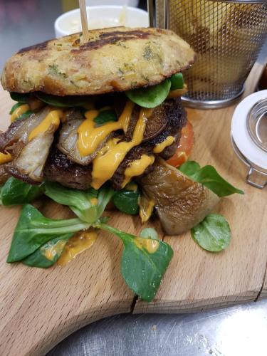 a sandwich on a cutting board on a table at Hotel Schempp in Bobingen