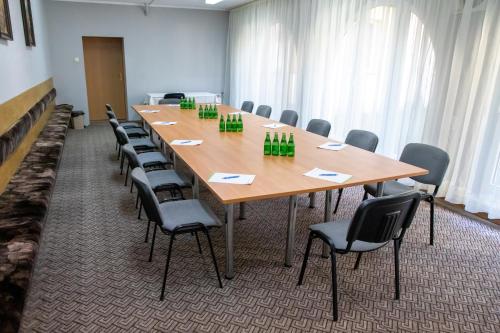 a conference room with a large wooden table and chairs at Zacisze Natura Tour in Spała