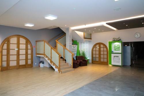 a lobby with wooden doors and stairs in a building at Zacisze Natura Tour in Spała