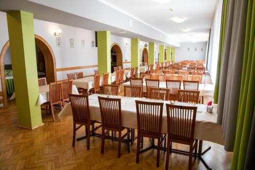 a large room with a long table and chairs at Zacisze Natura Tour in Spała