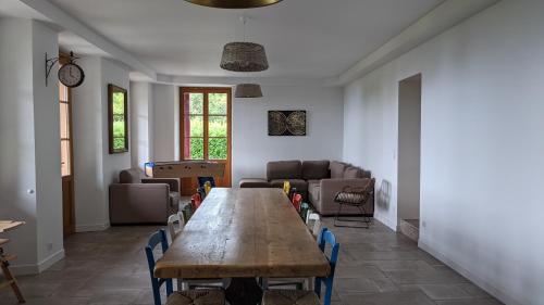 a living room with a wooden table and chairs at Gîte Les Vernes du Léman 11 à 13 pers in Maxilly-sur-Léman