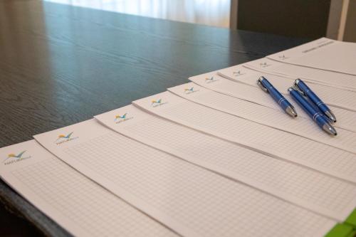 a group of papers sitting on a table with pens at Zacisze Natura Tour in Spała
