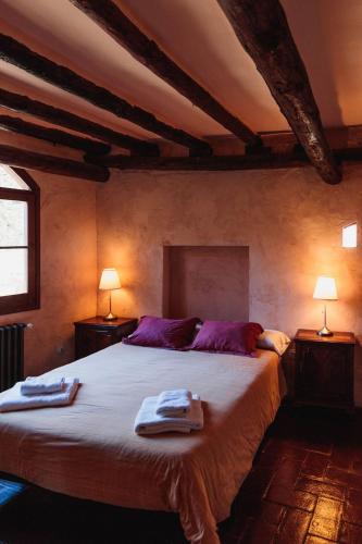 a bedroom with a large bed with towels on it at Mas Teixidor in Crespiá