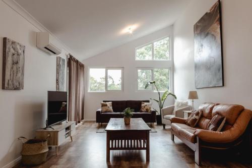 a living room with a couch and a table at Premalaya in Yallingup