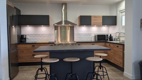 a kitchen with a blue counter and stools at Gîte Les Vernes du Léman 11 à 13 pers in Maxilly-sur-Léman