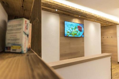 a television on a wall in a store at Apart&Chalet Chiara in Neustift im Stubaital
