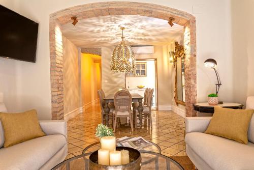 a living room with a table and a dining room at Genteel Home Recogidas in Granada