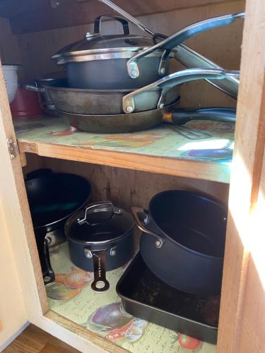 a shelf with pots and pans in a kitchen at 35 Flinders Ave in Dunwich