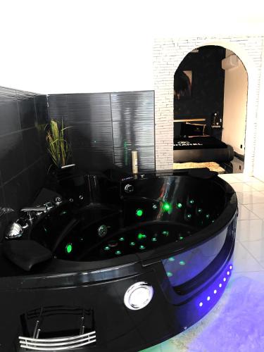 a black bath tub with green lights in a bathroom at #BBSH in Goussainville