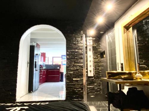a hallway with an archway in a room with a table at #BBSH in Goussainville