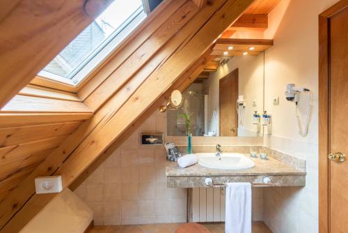 a bathroom with a sink and a window at Hotel Vielha Val d'Aran, Affiliated by Meliá in Vielha