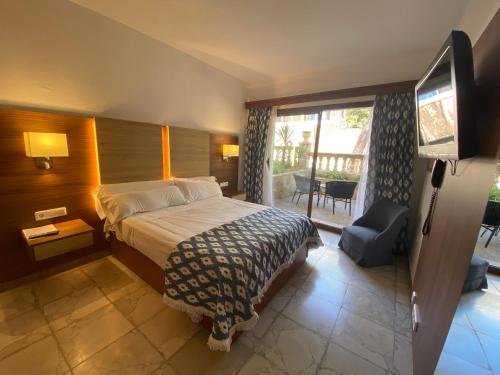 a hotel room with a bed and a television at Hs Villa Rosa Paguera in Paguera