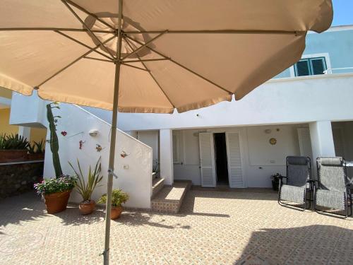 a large umbrella sitting on a patio at PonzaSmeralda Le Forna in Ponza