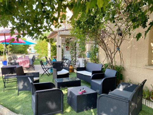 a group of chairs and tables in a yard at Hotel Carina in Apt
