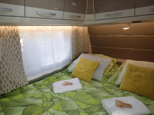 a bed in a room with two towels on it at Apartamenty u Łukasza in Zakopane