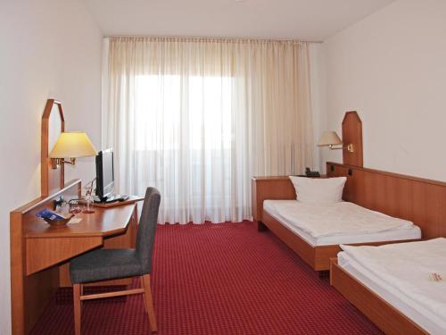 Ένα ή περισσότερα κρεβάτια σε δωμάτιο στο Sportpark Hugstetten