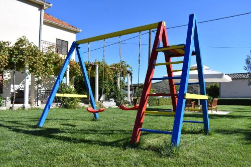 a swing set in a yard at Apartments Svilan in Trogir