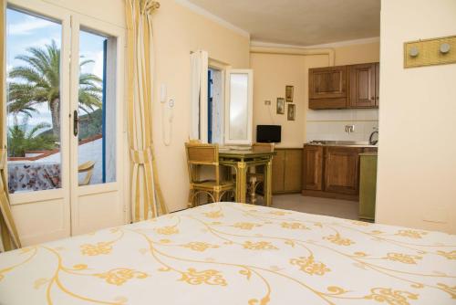 a bedroom with a bed and a kitchen with a window at Residential Hotel Villaggio Innamorata in Capoliveri