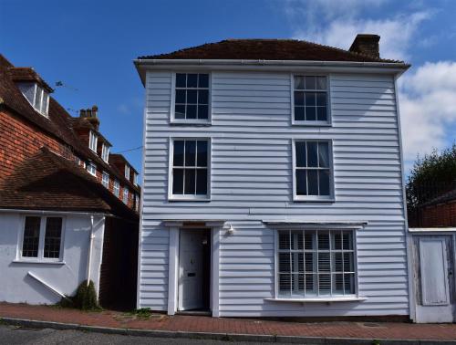 a white house with a white door and windows at Matchbox in Winchelsea