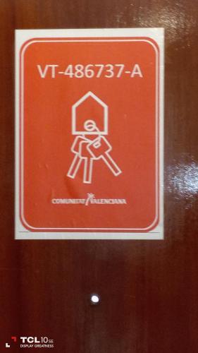 a red sign on a door with a person on it at Apartamento Veracruz - Primera Linea de Playa in Benidorm