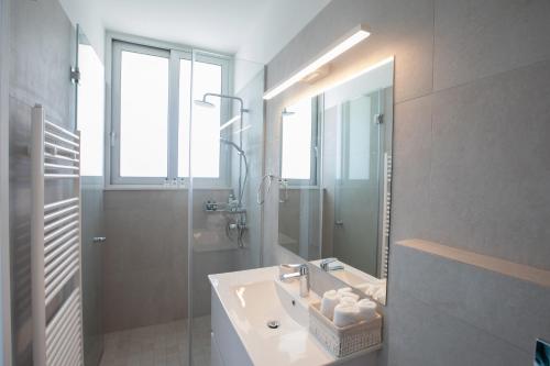 a bathroom with a sink and a shower and a mirror at Villa Olivine Pearl 3 in Protaras