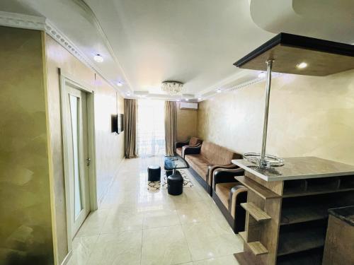 a living room with a couch and a table at Apartment in Orbi Residence in Batumi