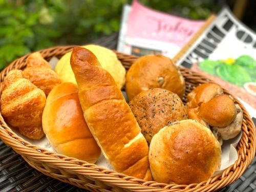 a basket of bread and pastries on a table at HOTEL TABARD TOKYO in Tokyo