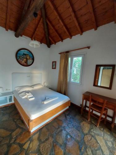 sypialnia z dużym łóżkiem i stołem w obiekcie Beautiful house wiht sea view in Samos Island w mieście Koumeika