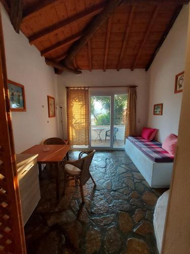 a bedroom with a bed and a desk and a table at Beautiful house wiht sea view in Samos Island in Koumeika
