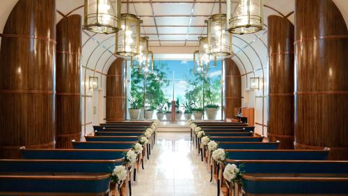 a row of chairs in a church with flowers on them at InterContinental Yokohama Grand by IHG in Yokohama