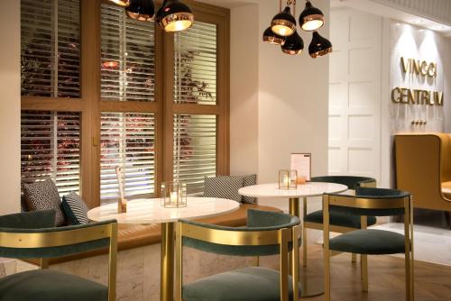 a restaurant with two tables and chairs and windows at Vincci Centrum in Madrid