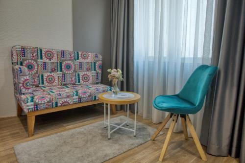 a living room with a couch and a table and a chair at OLD TOWN Apartments by Nejra in Sarajevo