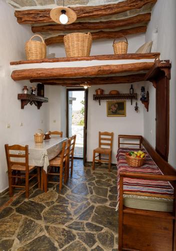 a dining room with a table and chairs at Itonia House in Amorgos