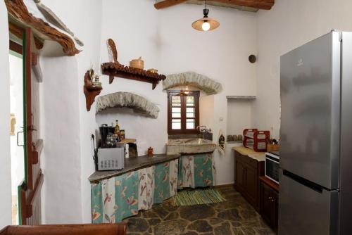 a kitchen with a refrigerator and a counter top at Itonia House in Amorgos