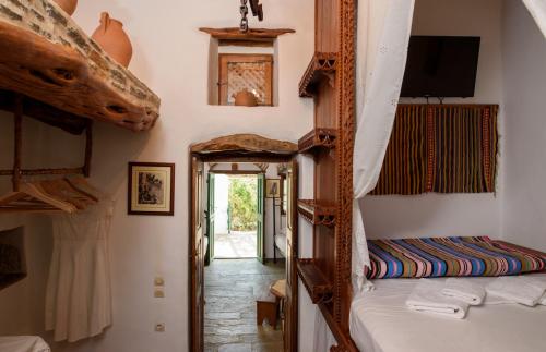 a room with two bunk beds and a hallway at Itonia House in Amorgos