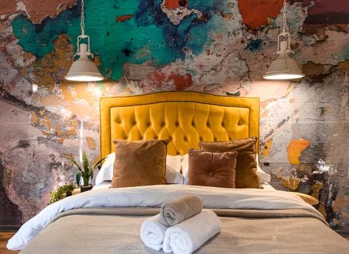 a bedroom with a bed and a painting on the wall at Lush in Graskop
