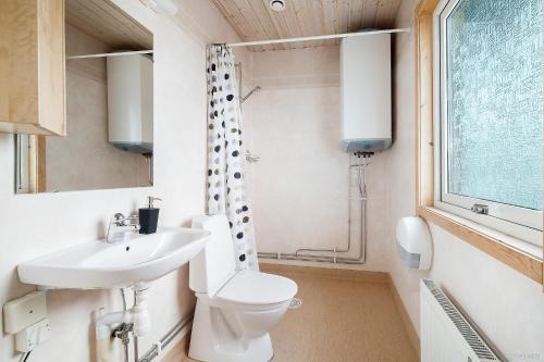 a bathroom with a toilet and a sink at First Camp Björknäs-Boden in Boden