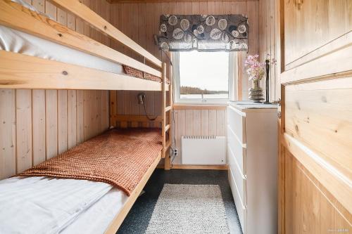 a small room with bunk beds and a window at First Camp Björknäs-Boden in Boden
