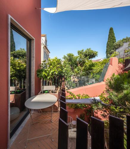 a balcony with a table and chairs on a building at toctoctoc lisboa in Lisbon