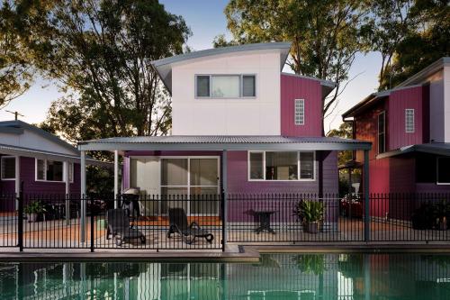 a house with a pool in front of it at Ingenia Holidays Hunter Valley in Cessnock