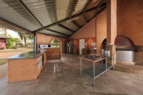 a large kitchen with a stove and a counter top at Ingenia Holidays Hunter Valley in Cessnock