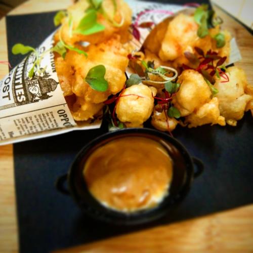 a plate of food with a bowl of dipping sauce at Vincci Soma in Madrid