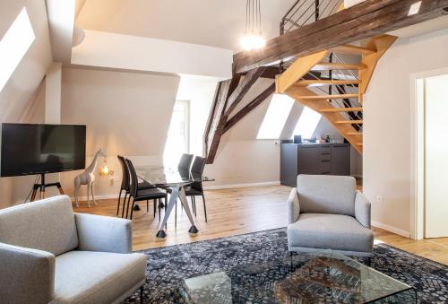 a living room with a table and chairs at Boutique Hotel Dom - Rooms & Suites in Graz