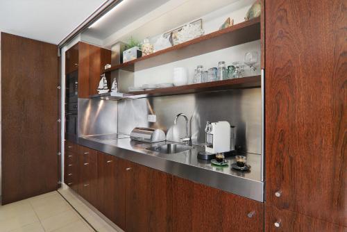 a kitchen with a sink and a coffee maker at Salgados 4seasons Apartment in Albufeira