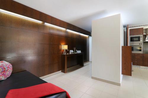 a room with a bed and a wooden wall at Salgados 4seasons Apartment in Albufeira