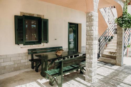 a patio with benches and a table and stairs at Apartmaji Pajer in Koper