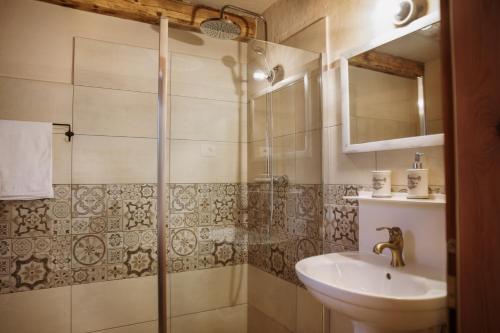 a bathroom with a sink and a shower at Apartmaji Pajer in Koper